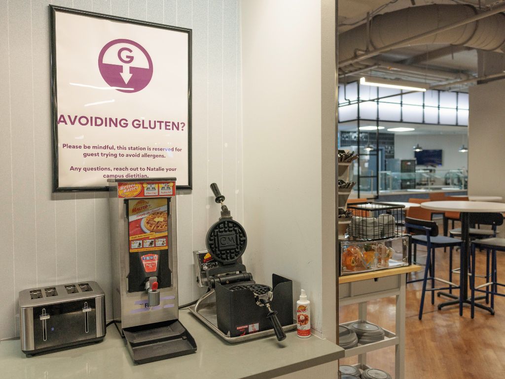 A dedicated gluten allergy food station in a GW dining hall with sign reading "Avoiding Gluten?"