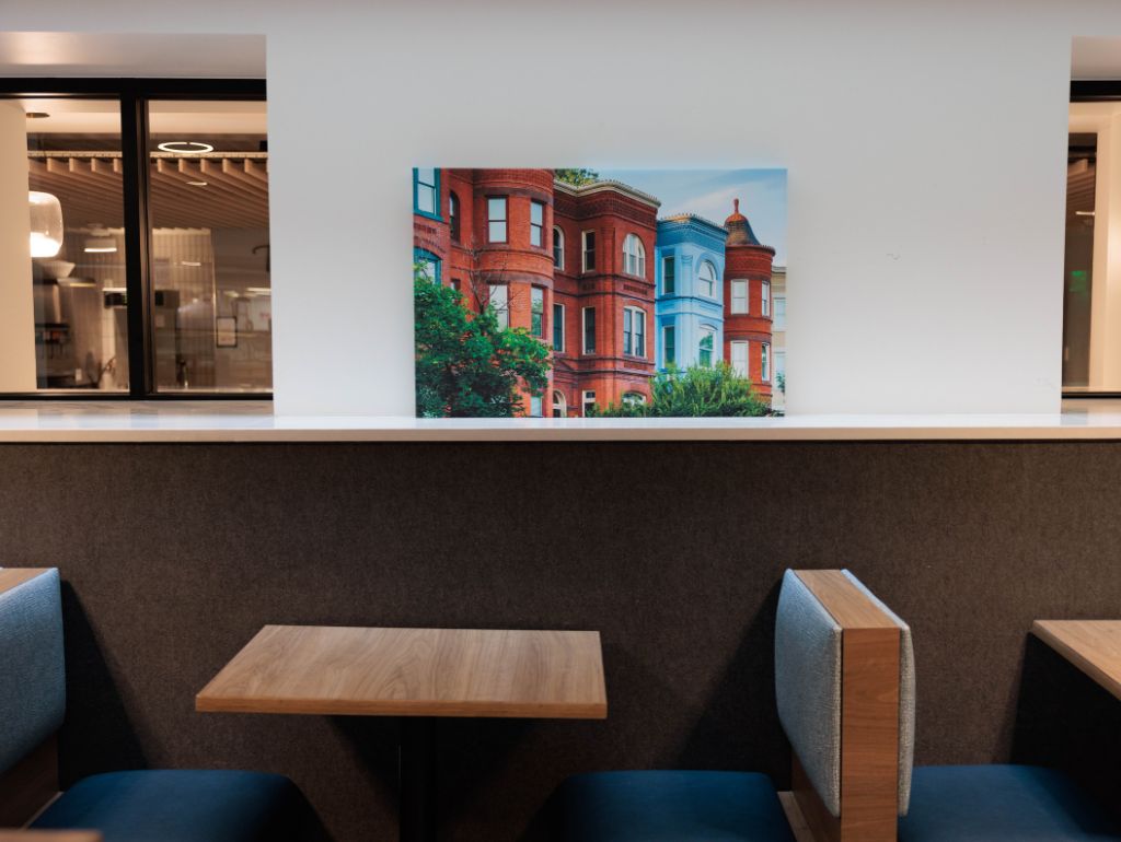 GW dining hall booth seating with a painting above it