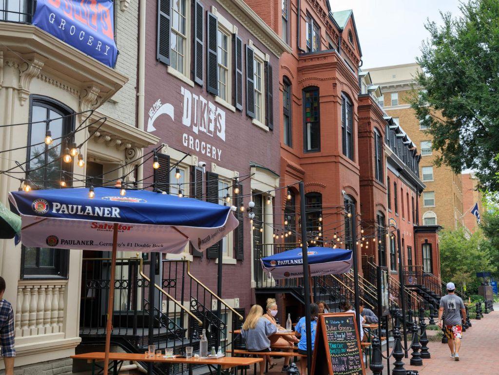 A D.C. street featuring "Duke's Grocery," a GW dining partner