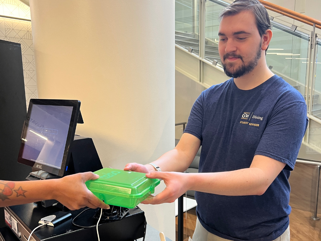 OZZI Step 2: In exchange for your OZZI token, the cashier will give you a clean to-go container. You will then take that to-go container and fill it with any food you would like from the line.