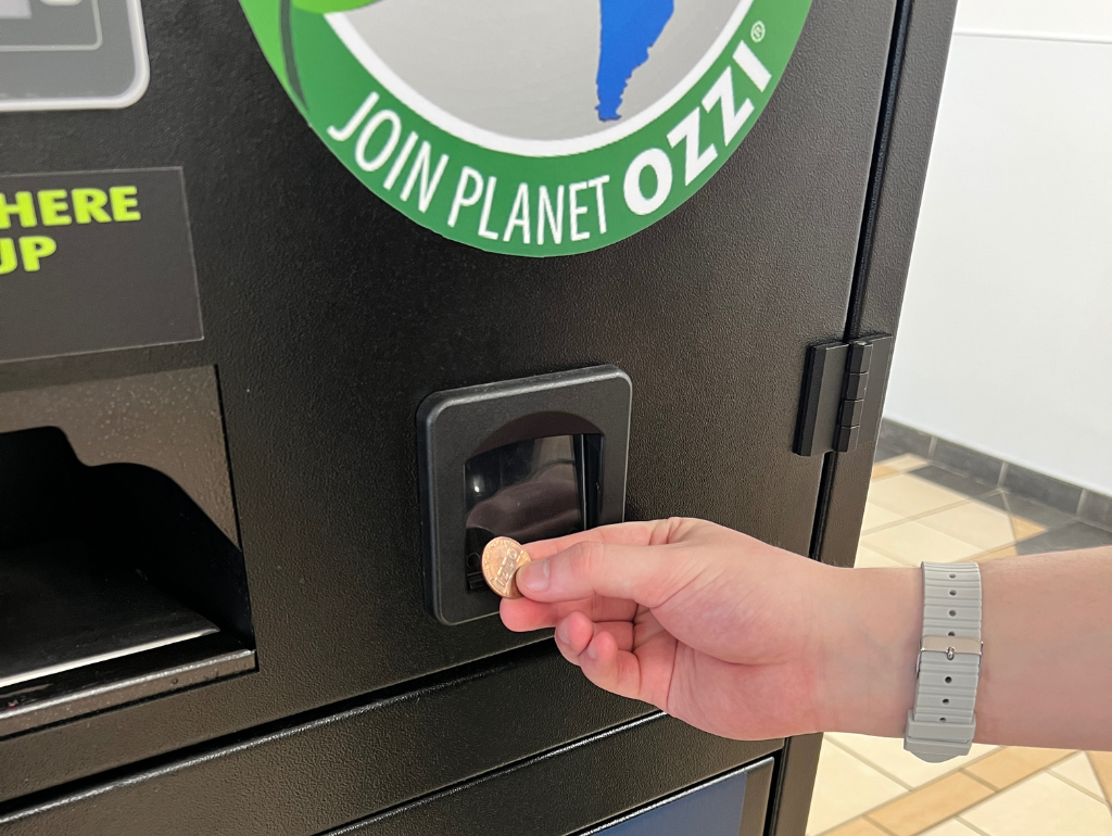 OZZI Step 5: The machine will then take your to-go container and deposit a new OZZI token for you to take from the coin slot. You are now ready to start the cycle over again!